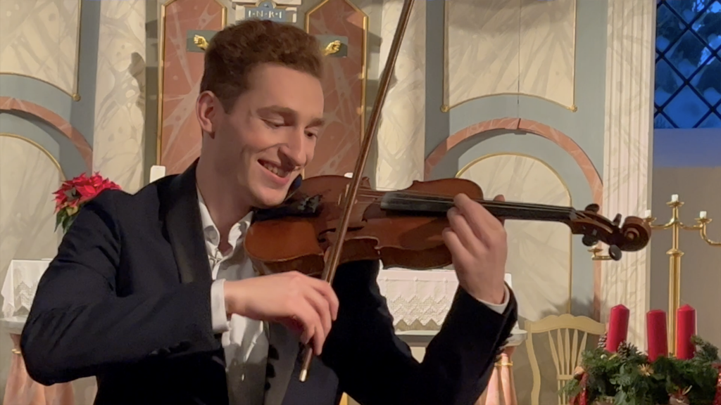 Violinist Paul Kolodziej (Musician) at a live performance of his Christmas Album Believe in the Church of Curau playing "God Bless Us Everyone" during the concert